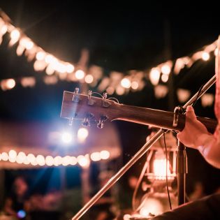 Musicians playing at night with lights sparkling