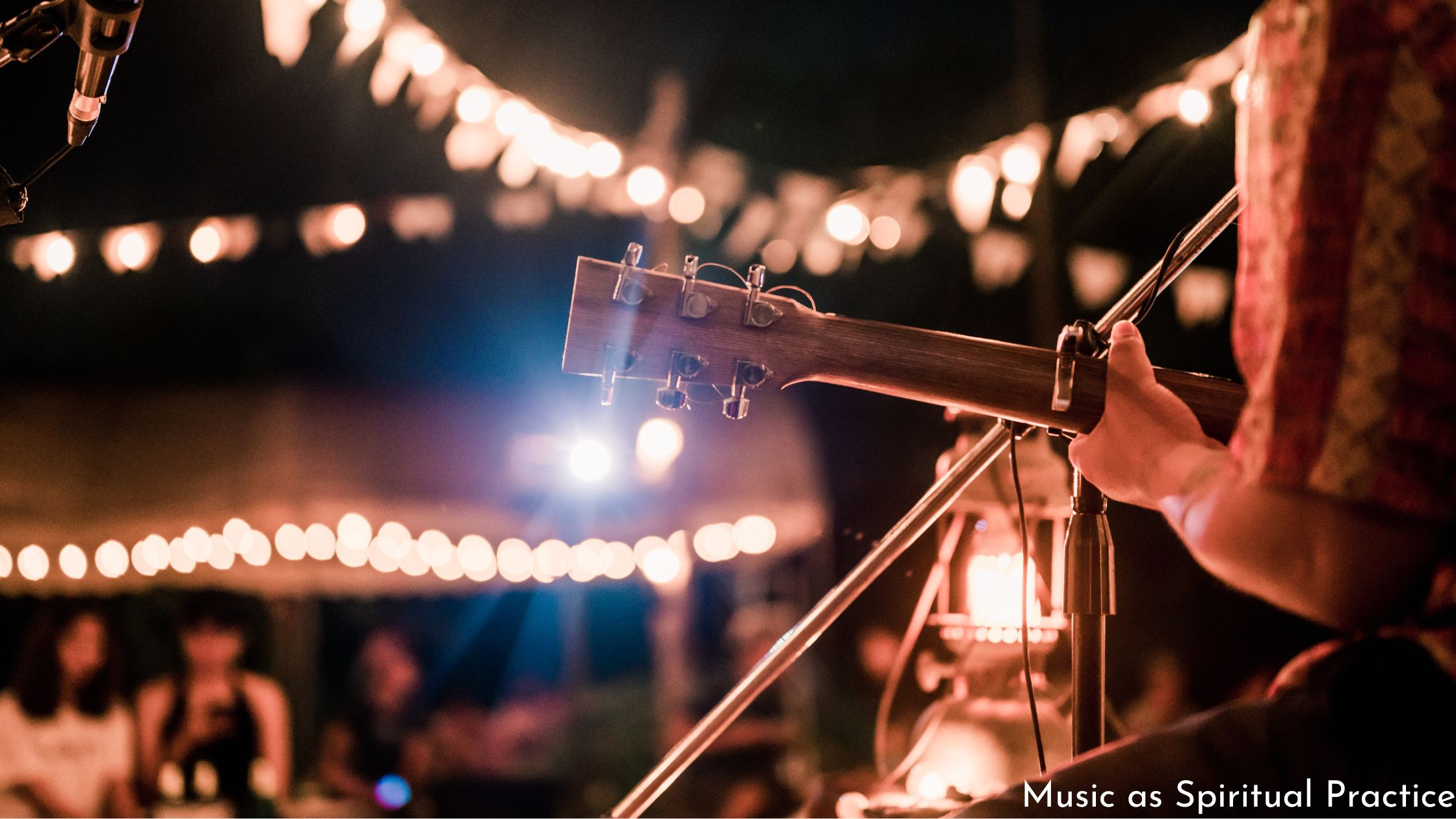 photo of musician playing at night with lights sparkling